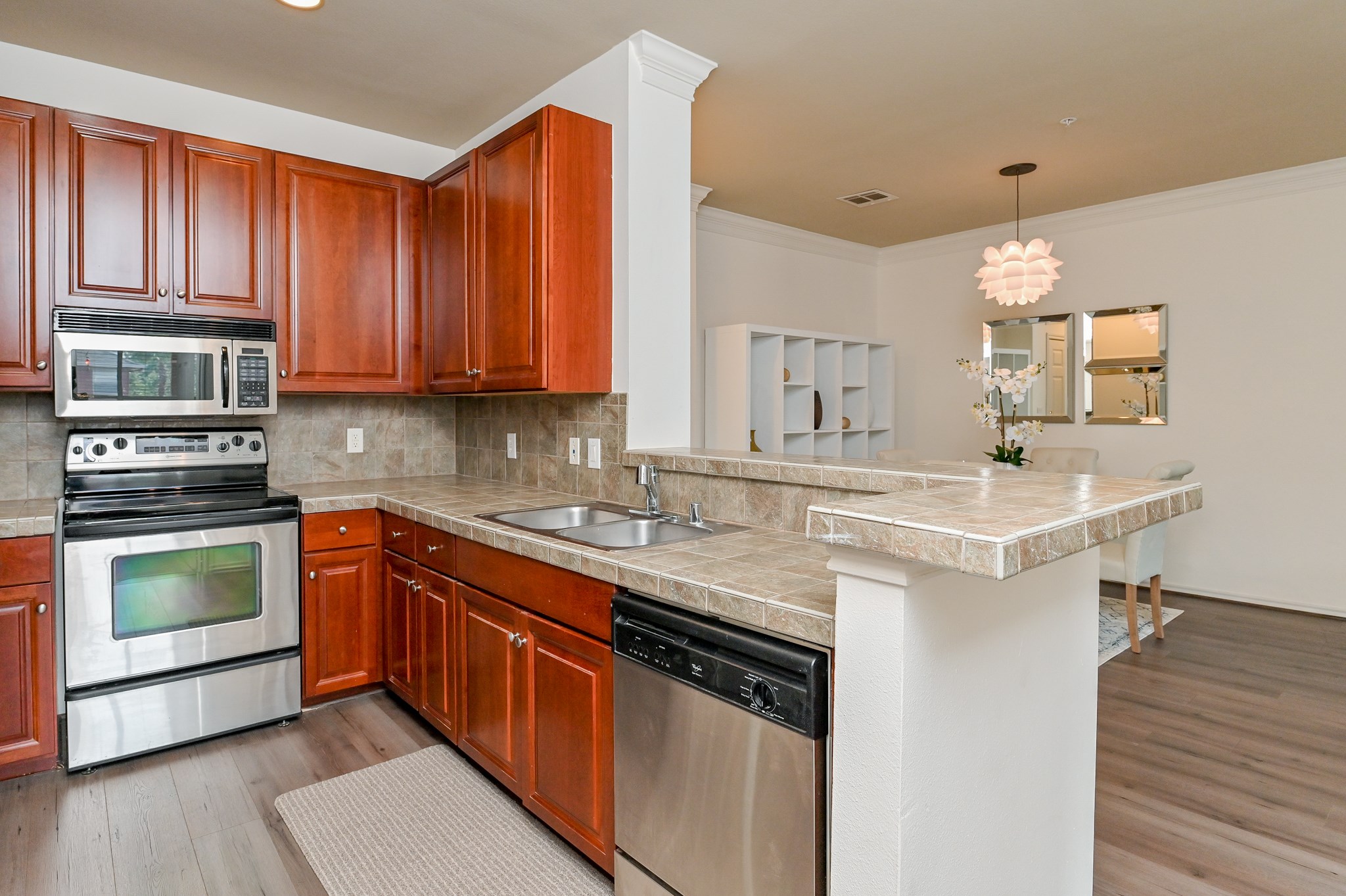 2400 McCue Road, Unit 443 Houston, TX 77056 - Photo 10 of 31 a kitchen with stainless steel appliances granite countertop a sink stove and cabinets