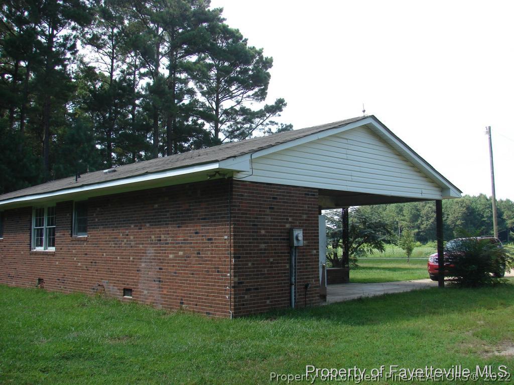 980 Carroll Store Road Autryville, NC 28318 - Photo 8 of 17 a backyard of a house with lots of green space