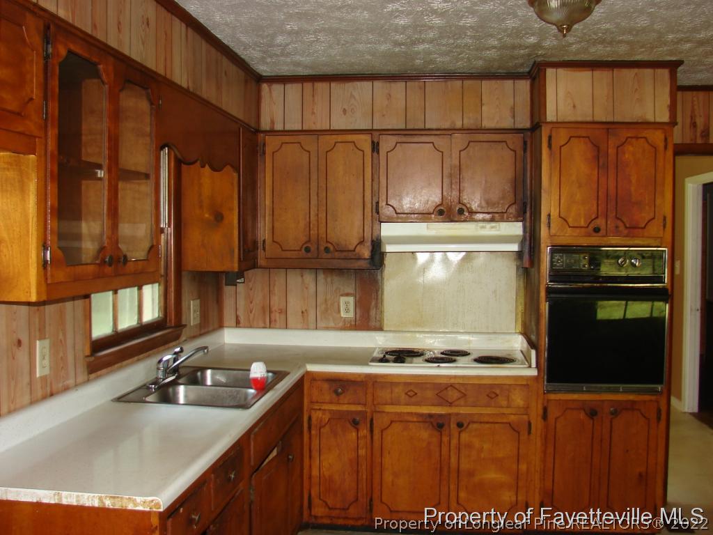 980 Carroll Store Road Autryville, NC 28318 - Photo 9 of 17 a kitchen with stainless steel appliances granite countertop a sink stove and refrigerator