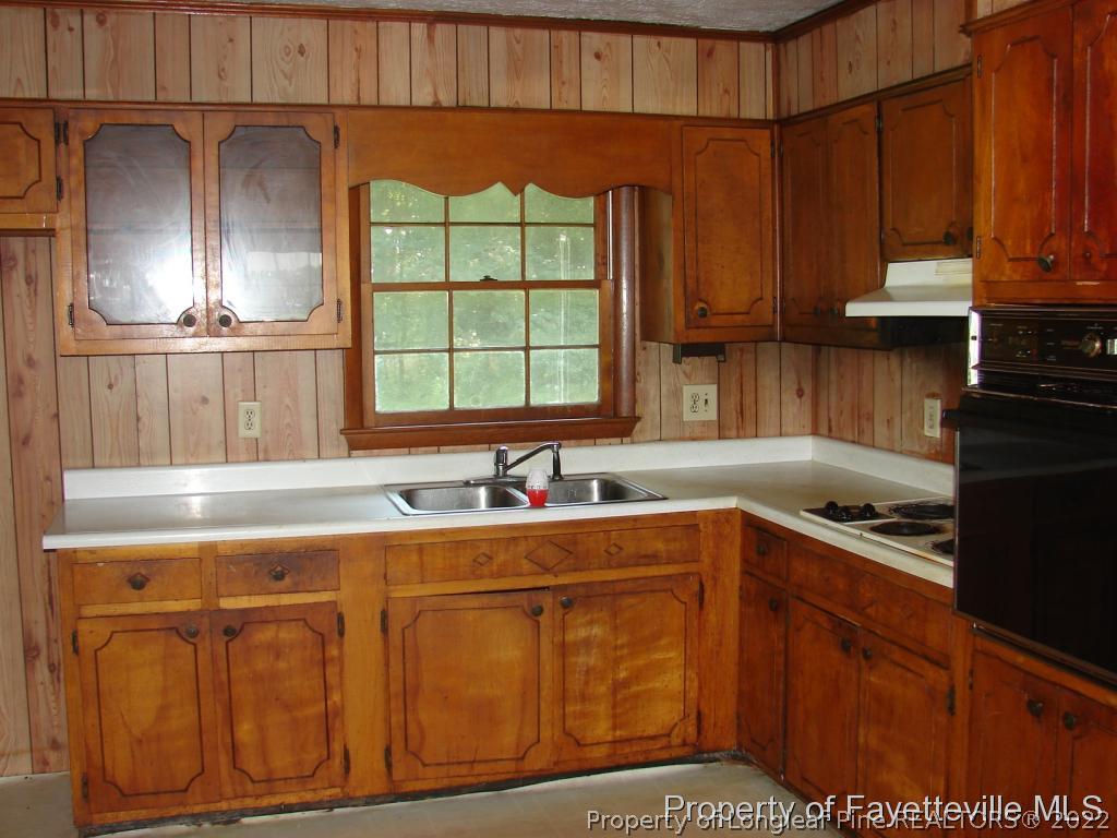 980 Carroll Store Road Autryville, NC 28318 - Photo 10 of 17 a kitchen with stainless steel appliances granite countertop a sink a stove and a refrigerator