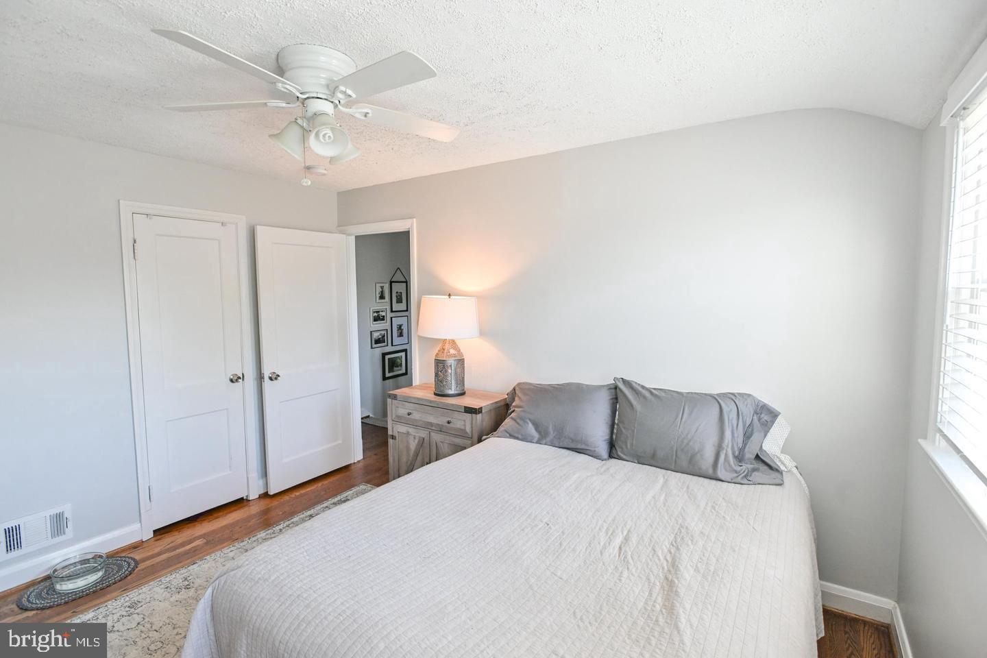 8321 Byington Road Towson, MD 21286 - Photo 11 of 28 a bedroom with a large bed and a chandelier