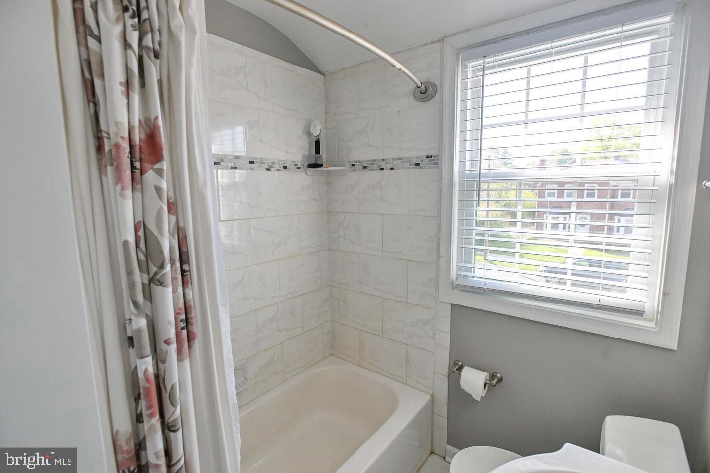8321 Byington Road Towson, MD 21286 - Photo 13 of 28 a bathroom with a shower a toilet and a window