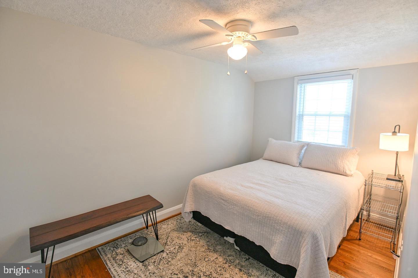8321 Byington Road Towson, MD 21286 - Photo 15 of 28 a bedroom with a bed and a chandelier