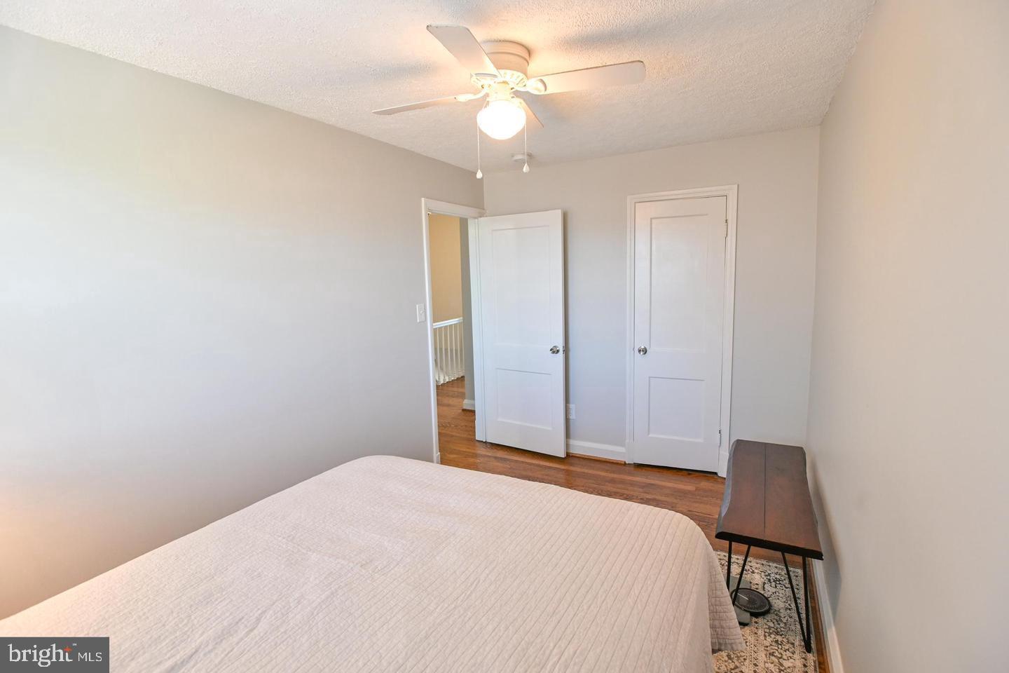 8321 Byington Road Towson, MD 21286 - Photo 16 of 28 a bedroom with a bed and a chandelier