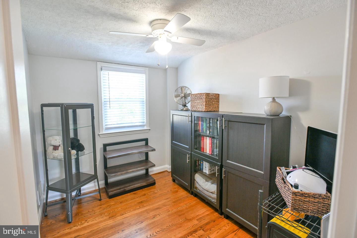8321 Byington Road Towson, MD 21286 - Photo 17 of 28 a bedroom with a bed and a chandelier
