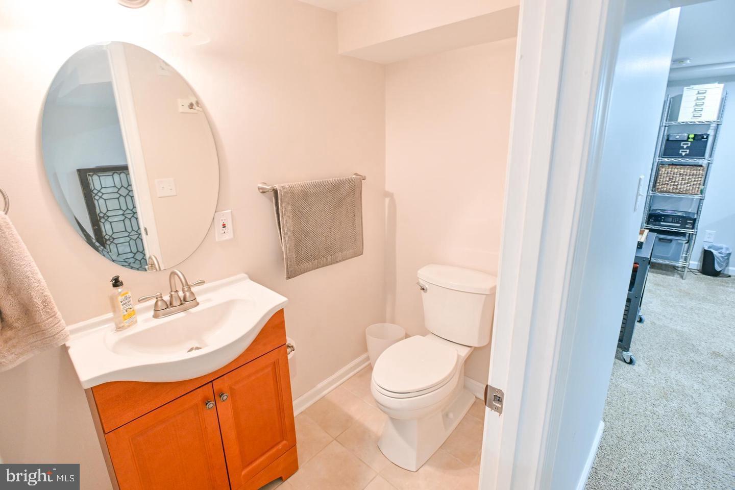 8321 Byington Road Towson, MD 21286 - Photo 22 of 28 a bathroom with a toilet sink and mirror