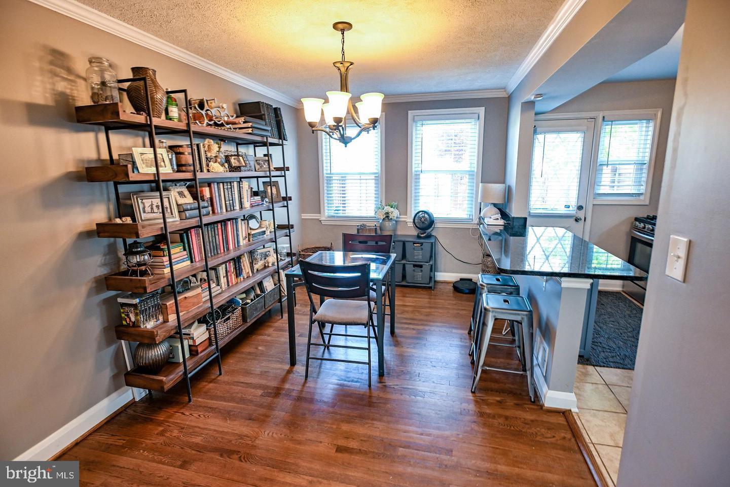 8321 Byington Road Towson, MD 21286 - Photo 6 of 28 a living room with furniture a rug and a book shelf