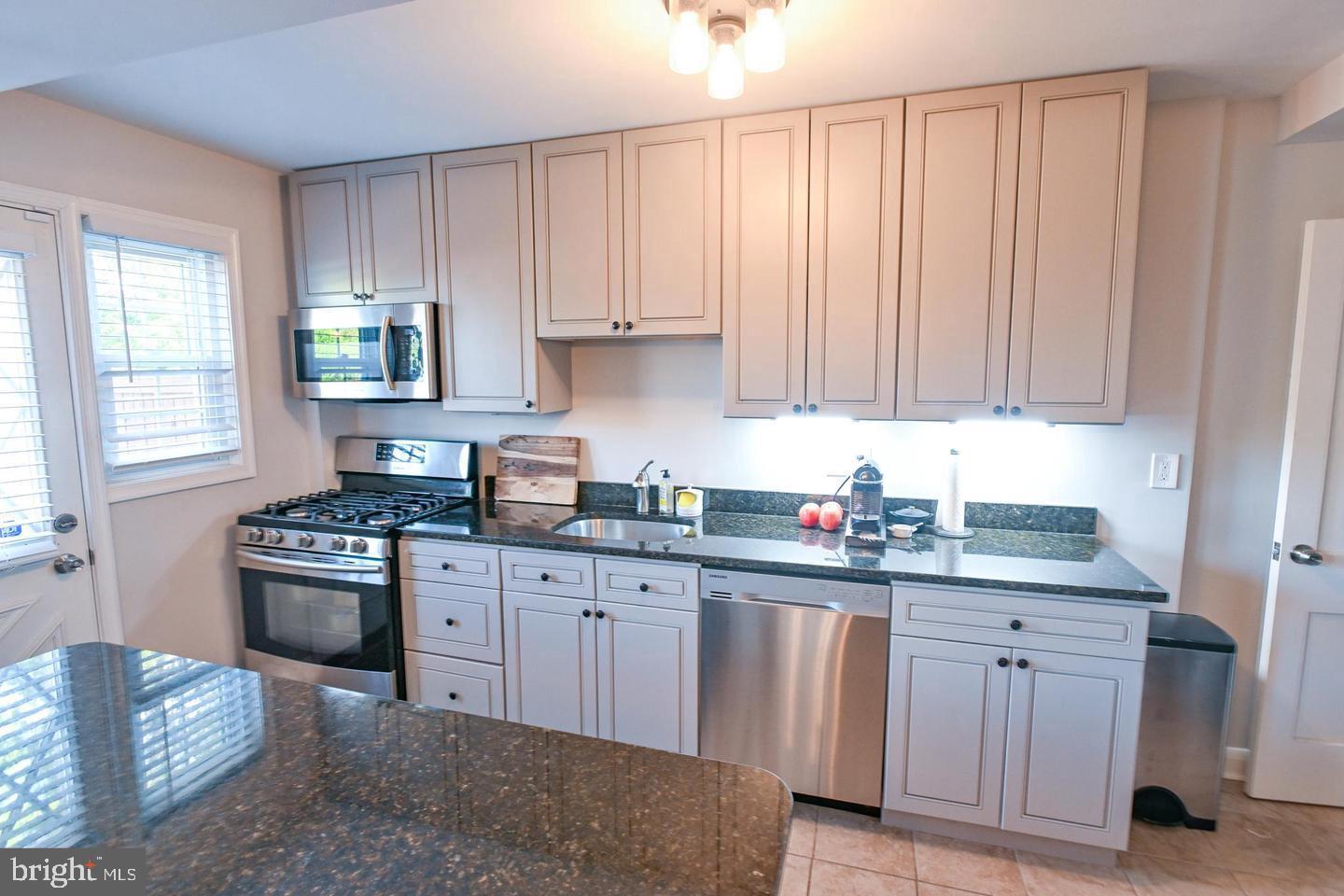 8321 Byington Road Towson, MD 21286 - Photo 8 of 28 a kitchen with cabinets appliances and a window