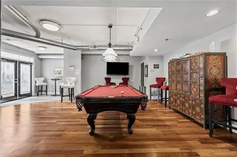 a room with furniture and pool table