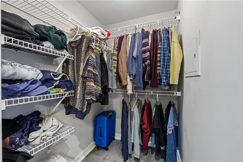 a view of walk in closet with clothes