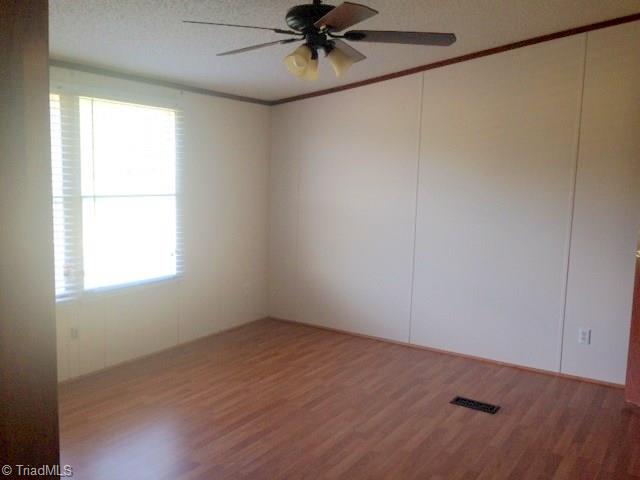 93 Green Pastures Lane Ruffin, NC 27326 - Photo 22 of 28 Master Bedroom with laminate floor