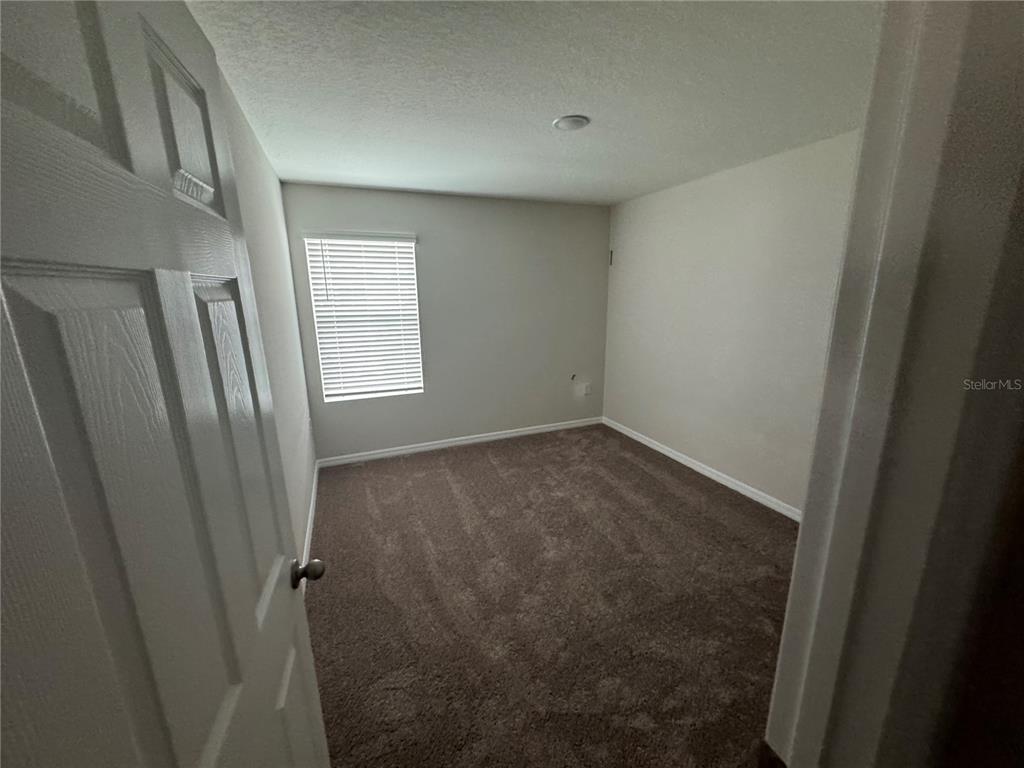7629 Hydrangea Lane Wesley Chapel, FL 33545 - Photo 11 of 15 a view of an empty room with a window