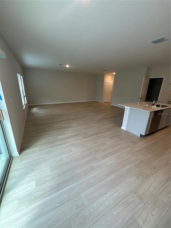 7629 Hydrangea Lane Wesley Chapel, FL 33545 - Photo 3 of 15 a view of a room with wooden floor and chair