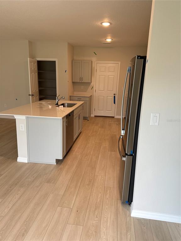 7629 Hydrangea Lane Wesley Chapel, FL 33545 - Photo 4 of 15 a large kitchen with stainless steel appliances a refrigerator and a stove top oven