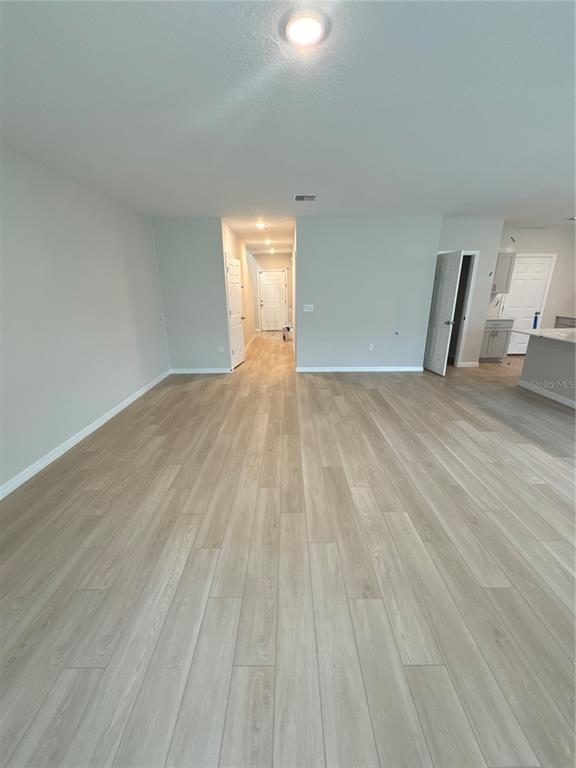 7629 Hydrangea Lane Wesley Chapel, FL 33545 - Photo 5 of 15 a view of empty room with wooden floor