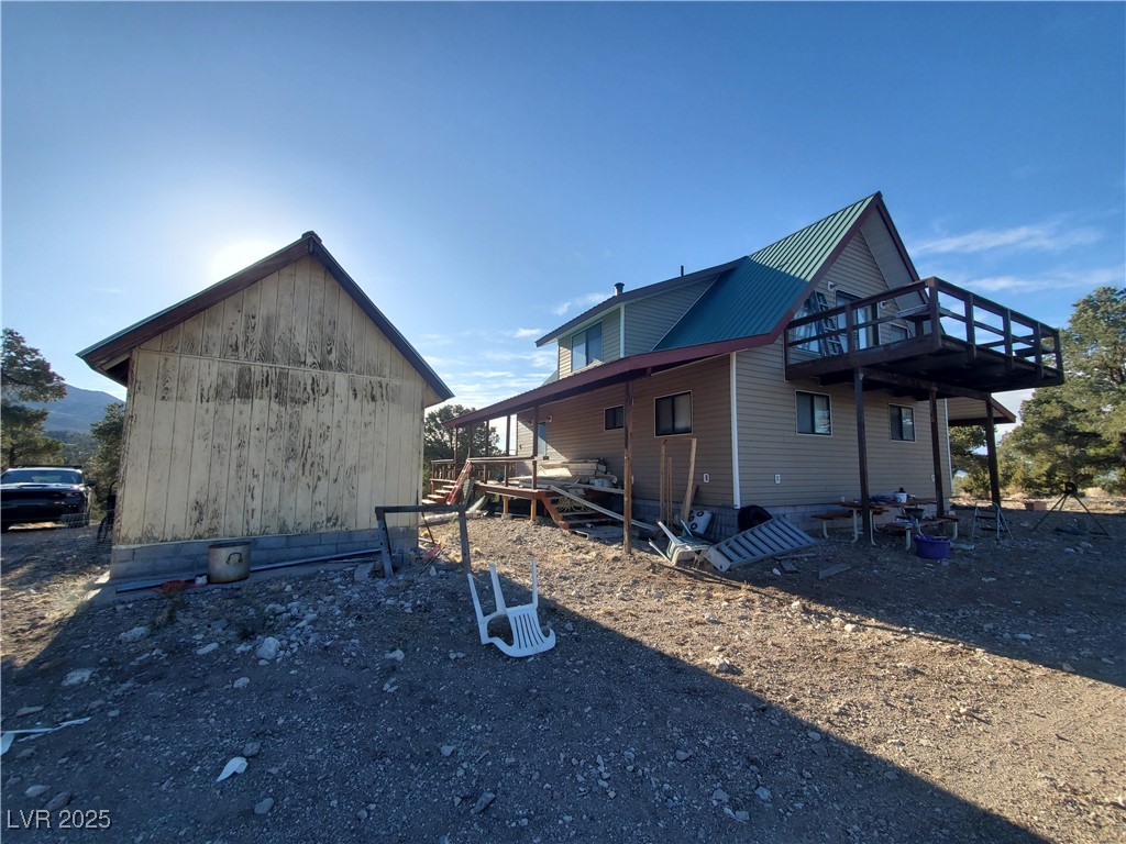 1281 Meadow Lane Pioche, NV 89043 - Photo 29 of 34 View of property exterior with an outbuilding, a wooden deck, and metal roof