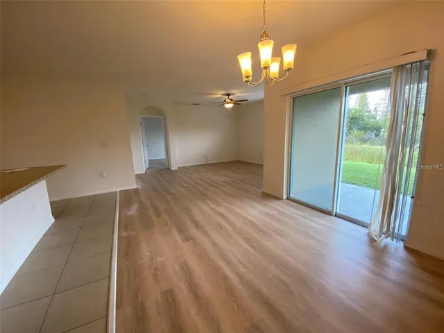 a view of a livingroom with a ceiling fan and window