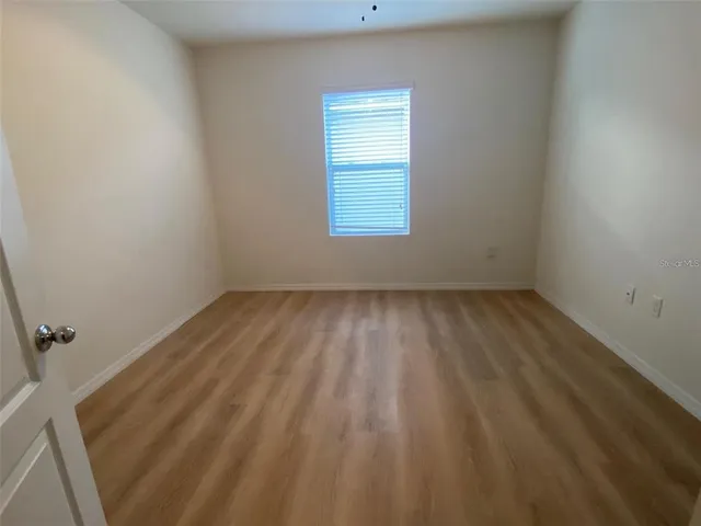 an empty room with wooden door