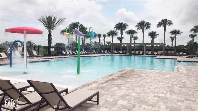 a view of a lake with table and chairs
