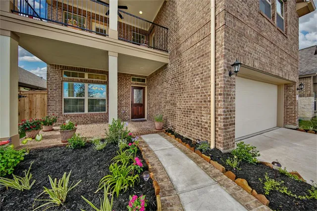 a view of a house with potted plants