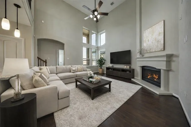 a living room with furniture a flat screen tv and a fireplace