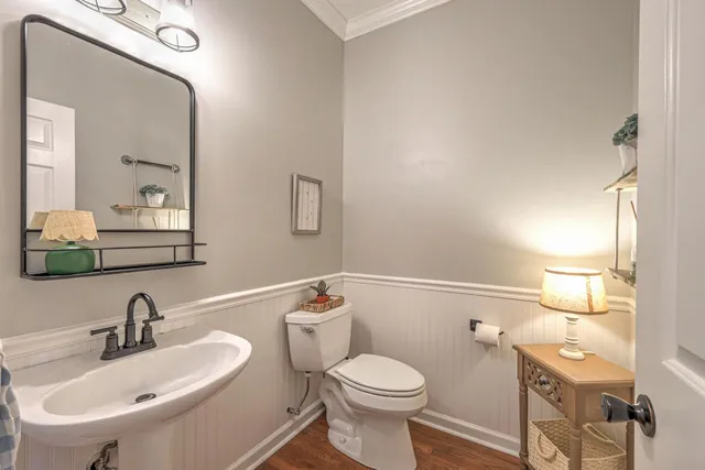 a kitchen with a center island wooden floor and stainless steel appliances