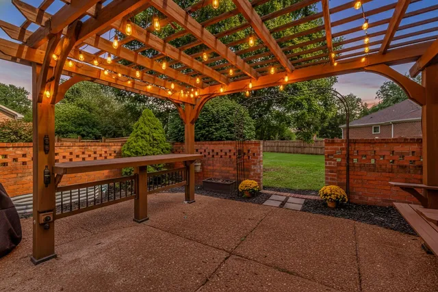 a view of a chairs and table in the backyard