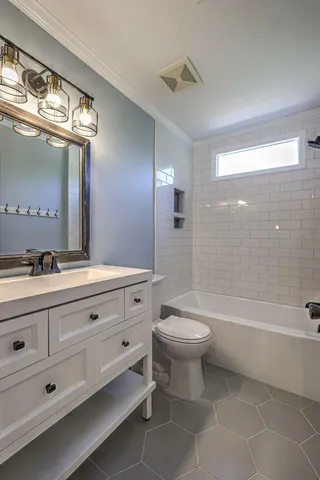 a view of a chairs and table in the patio next to a yard