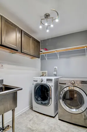 a utility room with sink dryer and washer