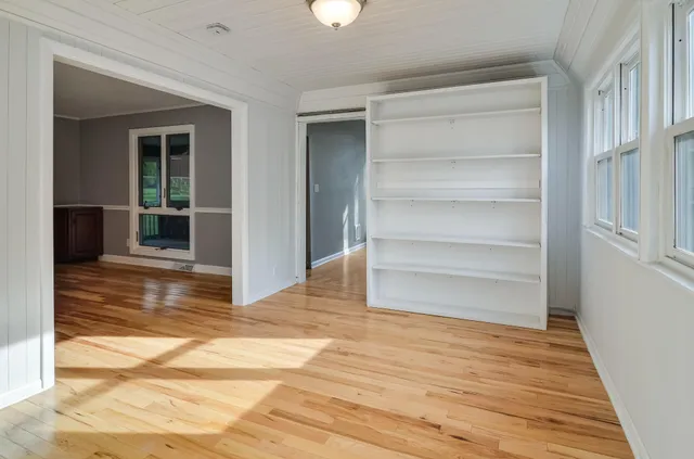a view of a room with wooden floor