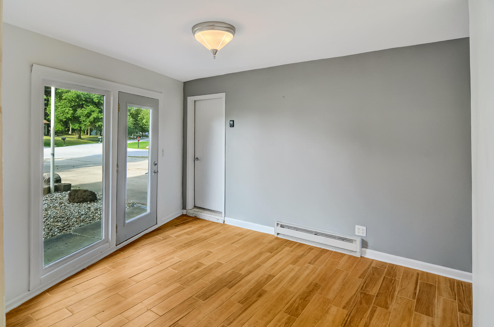2212 Elm Tree Lane Crown Point, IN 46307 - Photo 17 of 33 a view of an empty room with wooden floor and a window