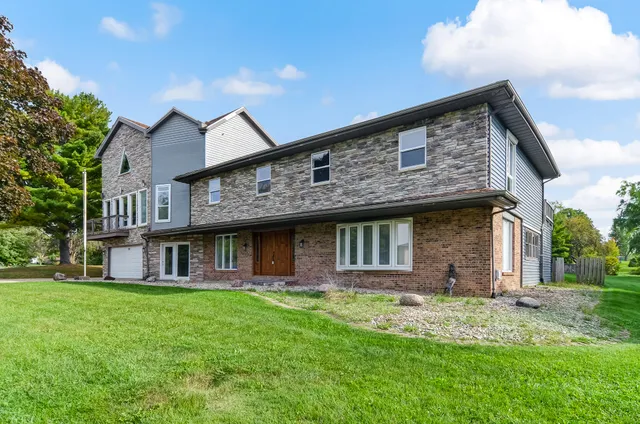 a front view of a house with a garden