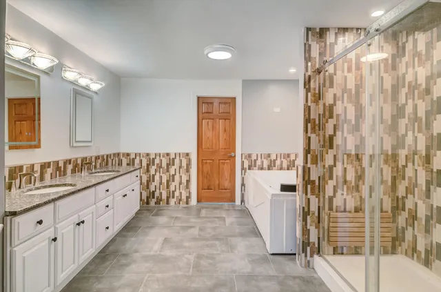 a bathroom with a double vanity sink and mirror