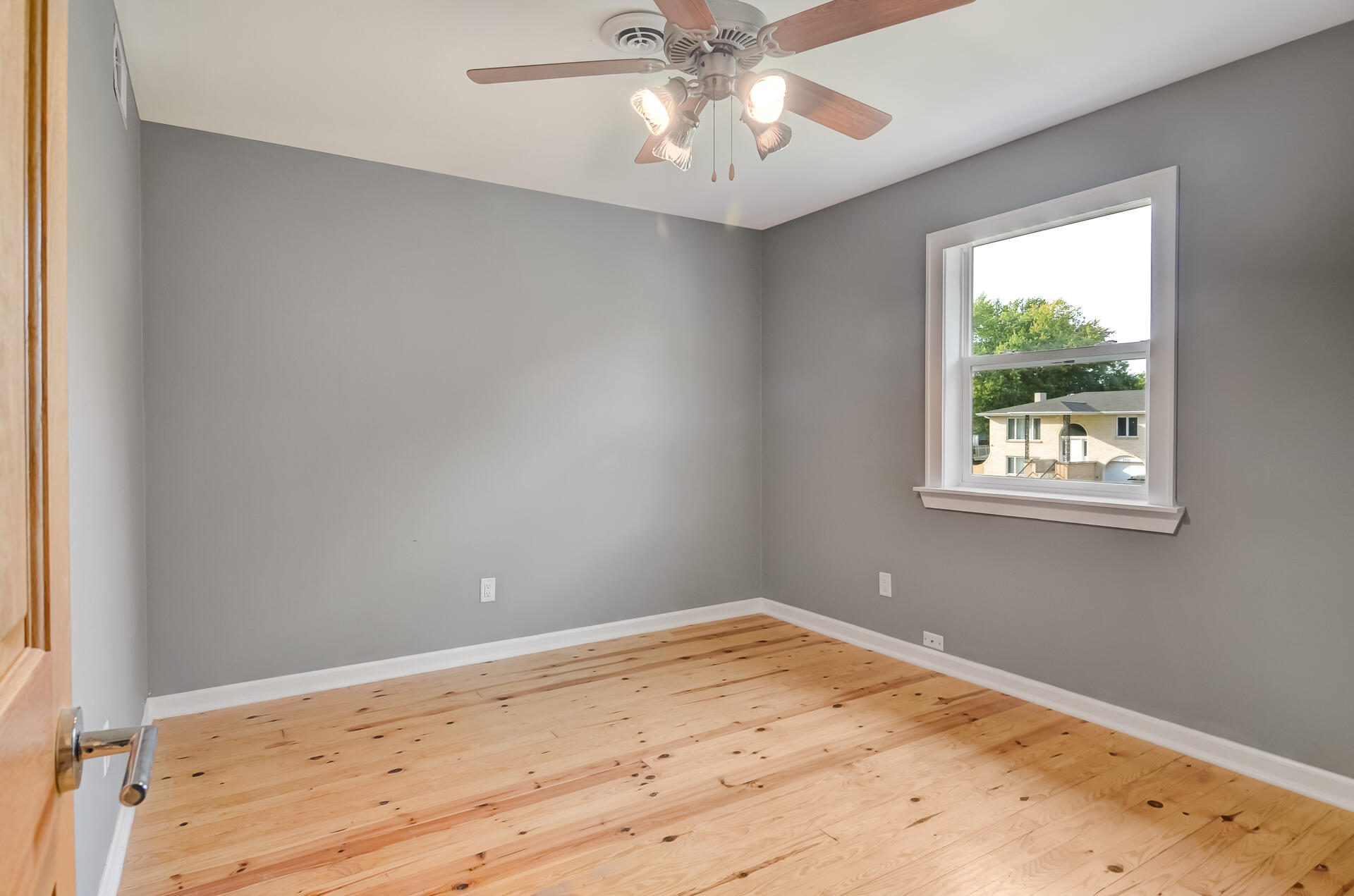 2212 Elm Tree Lane Crown Point, IN 46307 - Photo 26 of 33 a view of empty room with wooden floor and fan