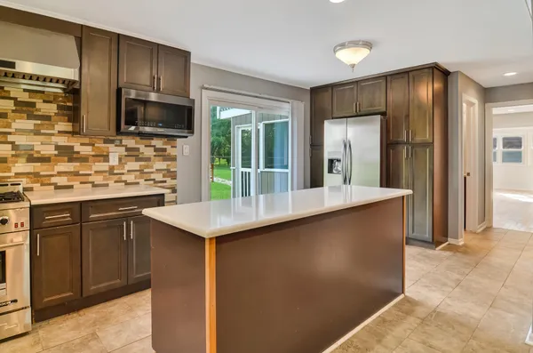 a kitchen with stainless steel appliances a sink stove and refrigerator