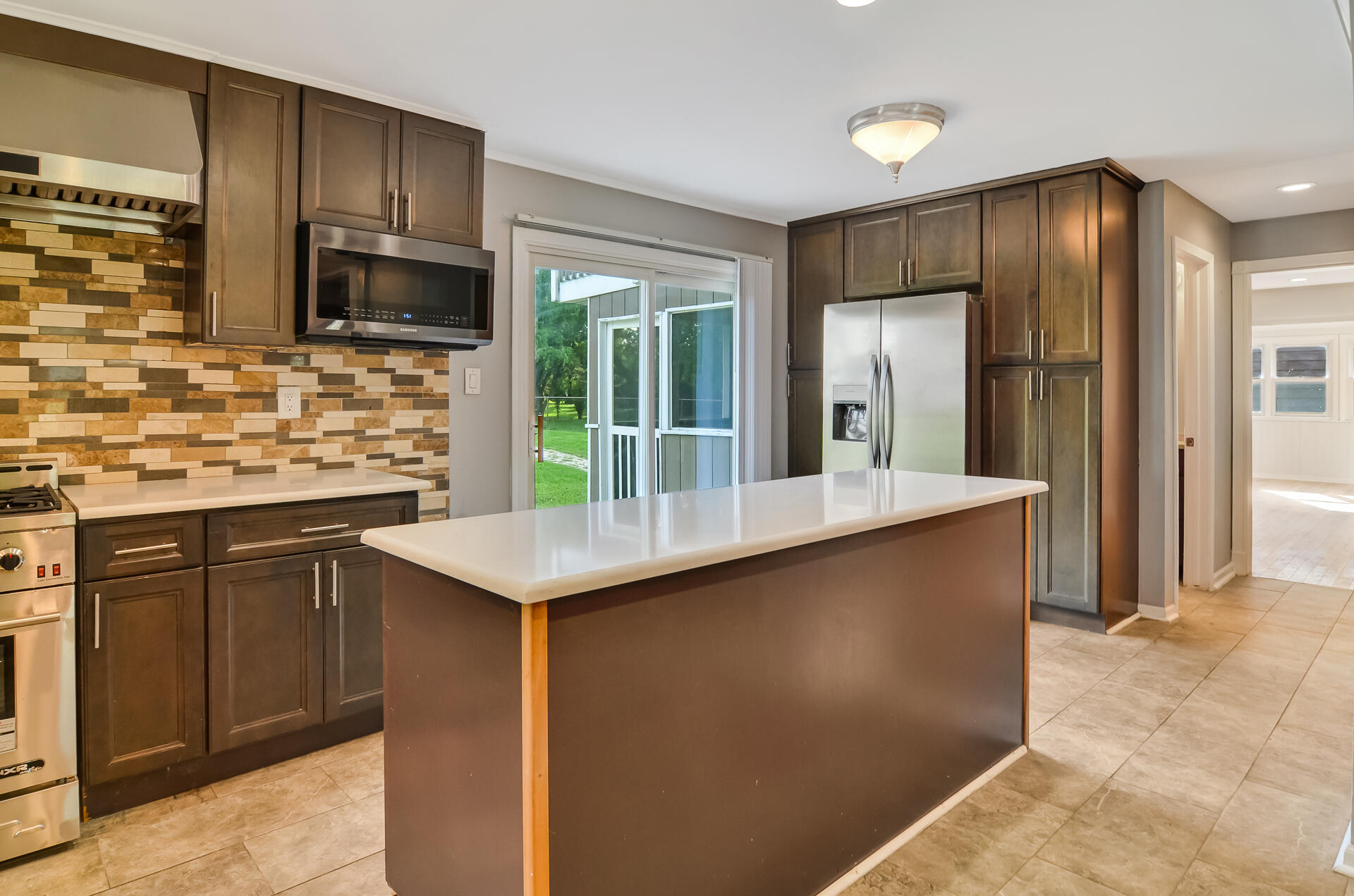 2212 Elm Tree Lane Crown Point, IN 46307 - Photo 9 of 33 a kitchen with stainless steel appliances a sink stove and refrigerator