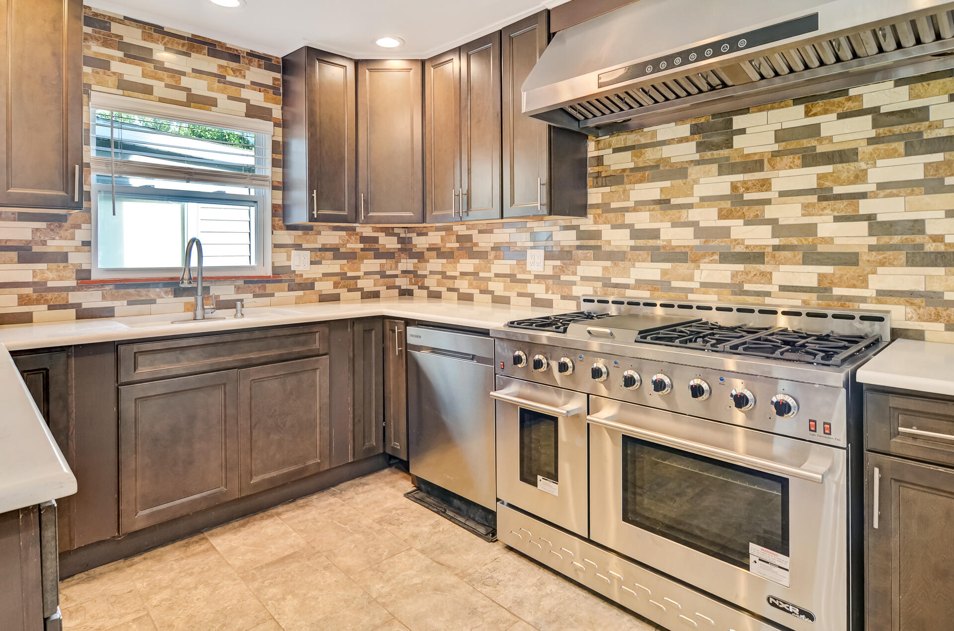 2212 Elm Tree Lane Crown Point, IN 46307 - Photo 10 of 33 a kitchen with a stove sink and cabinets