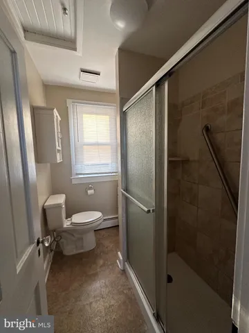 a bathroom with a toilet a sink and shower