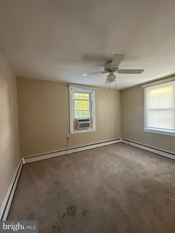 an empty room with a empty space and windows