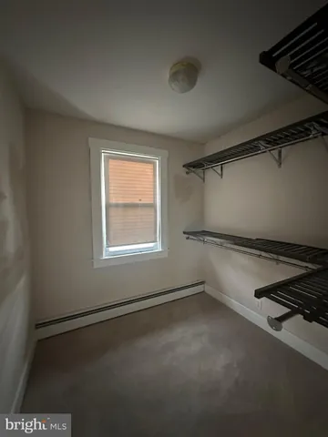 a view of a room with rack on the wall and a window