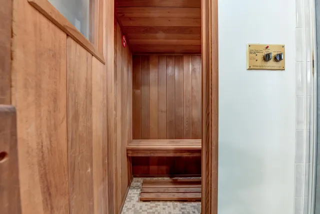 a bed room with a bed and a chair