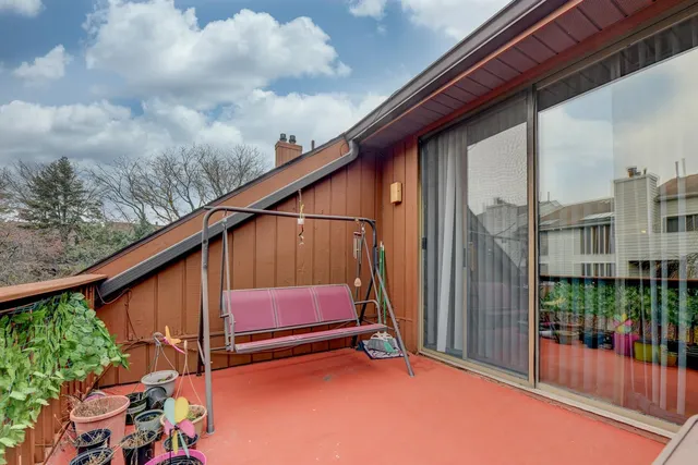 a view of a balcony with outdoor seating and plants