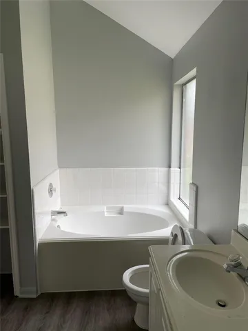 a bathroom with a bathtub and a sink