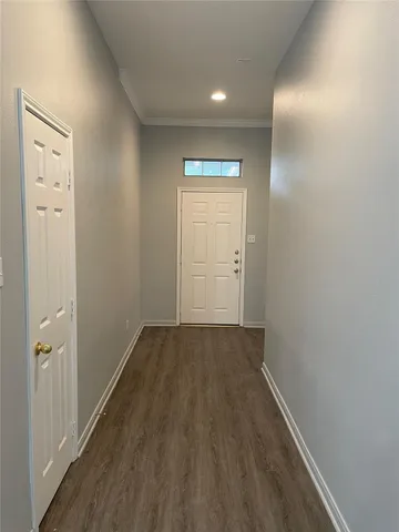 an empty room with wooden floor and closet