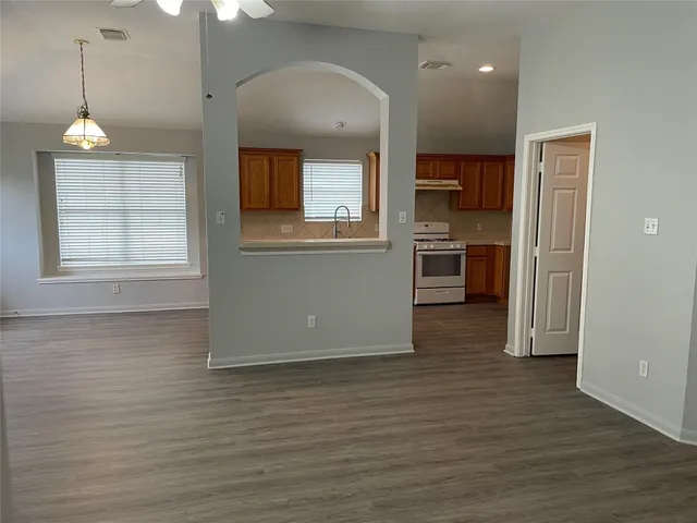 a view of a kitchen with a sink cabinets and wooden floor