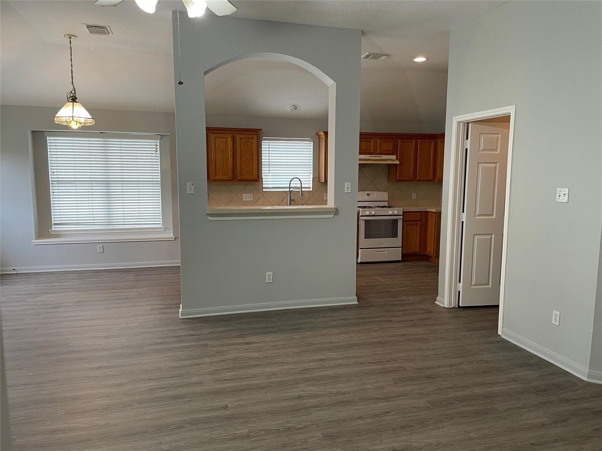 3310 North Mason Road Katy, TX 77449 - Photo 8 of 14 a view of a kitchen with a sink cabinets and wooden floor