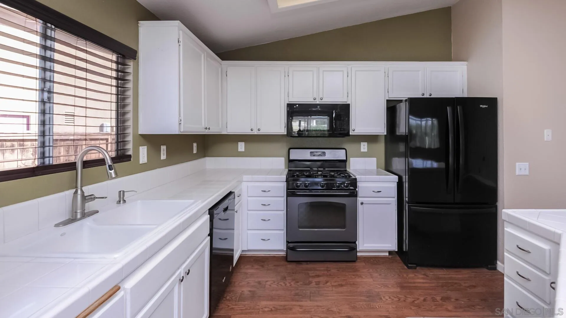 33092 Tulley Ranch Road Temecula, CA 92592 - Photo 3 of 24 a kitchen with a sink stove and refrigerator