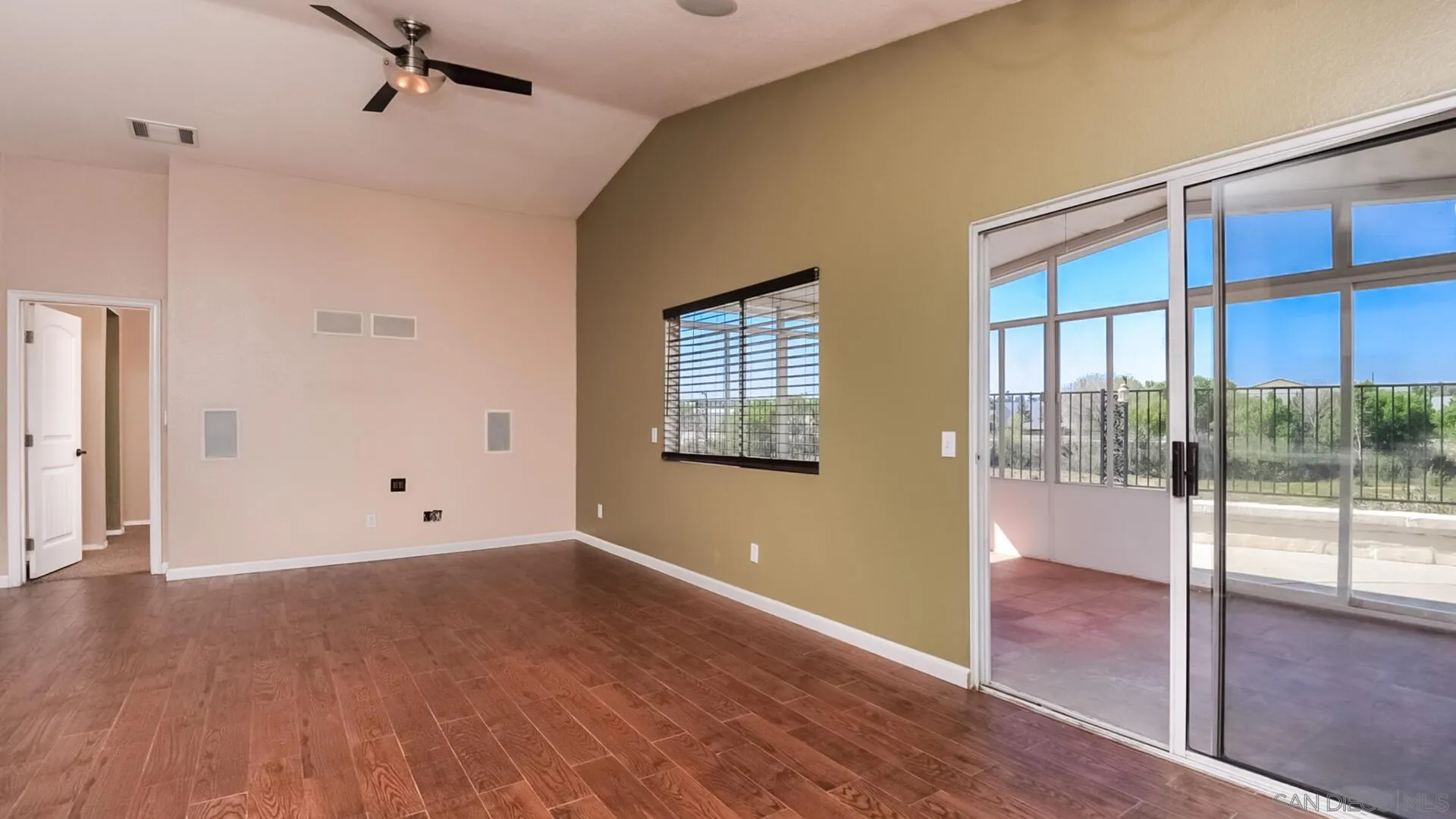 33092 Tulley Ranch Road Temecula, CA 92592 - Photo 7 of 24 a view of an empty room with wooden floor and a window
