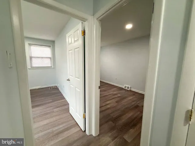 a view of a hallway with wooden floor and entryway