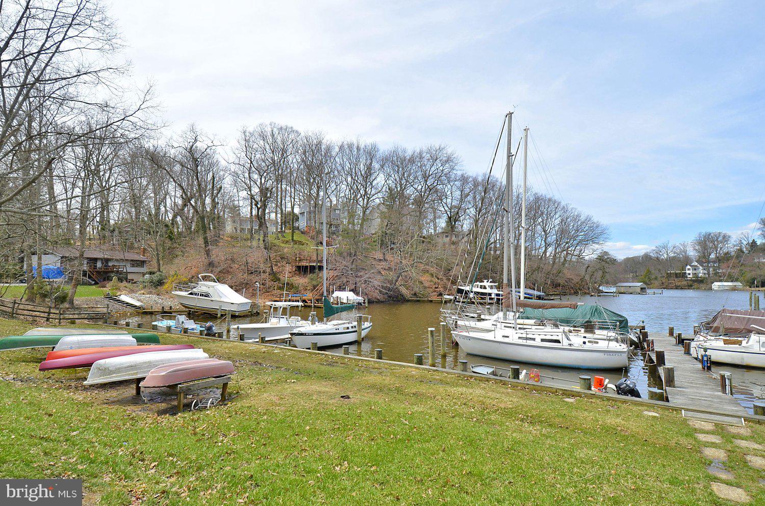 1518 Winchester Road Annapolis, MD 21409 - Photo 61 of 70 a view of a lake with lawn chairs and a fire pit